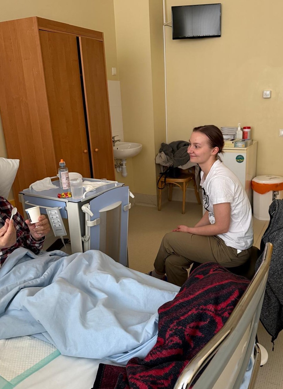 Dana sitting with a hospice patient